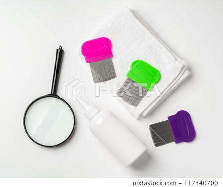 Medicine, lice comb and magnifying glass isolated on white 117340700