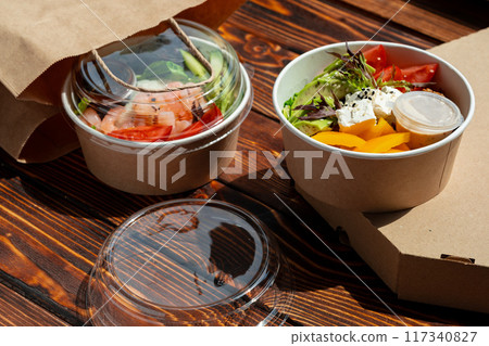 Take out poke bowl on wooden background 117340827