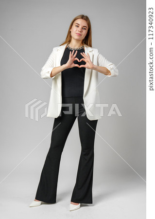 Woman Making Heart With Hands on gray background Woman Making Heart With Hands on gray background 117340923