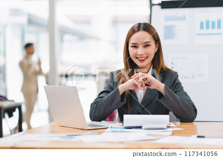 Confident asian businesswoman using laptop in meeting room. 117341056