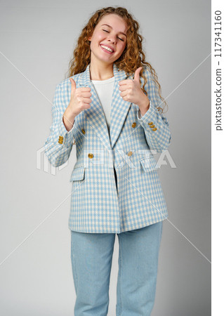Young Woman Giving Ok Sign on gray background 117341160