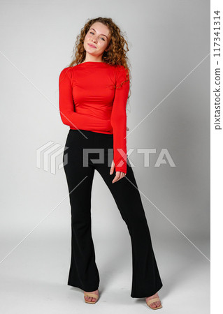 Young Woman With Curly Hair Portrait against gray background 117341314