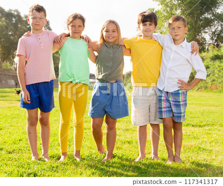Portrait of five glad children who are walking and posing in park Portrait of five glad children who are walking and posing in park 117341317
