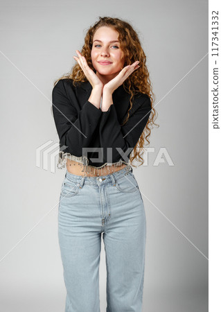 Woman With Curly Hair Standing on Gray Background 117341332