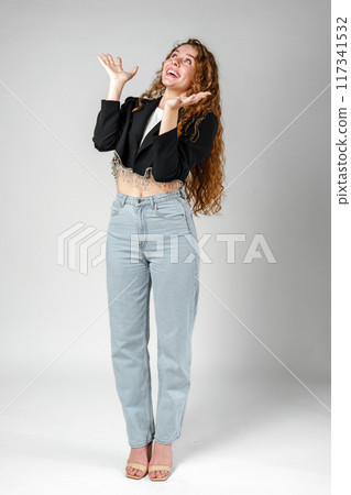Young Businesswoman Gesturing Excitement or Surprise Against a Neutral Background 117341532