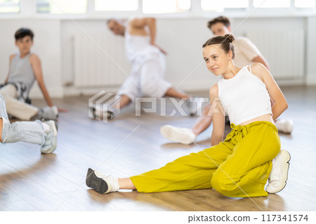 Teenage girl dancing breakdancing in group 117341574