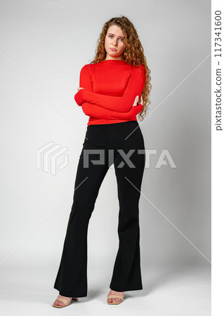 Young Woman With Curly Hair Expressing Concern 117341600