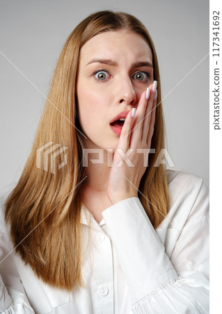 Young woman in a state of shock or surprise Young woman in a state of shock or surprise 117341692
