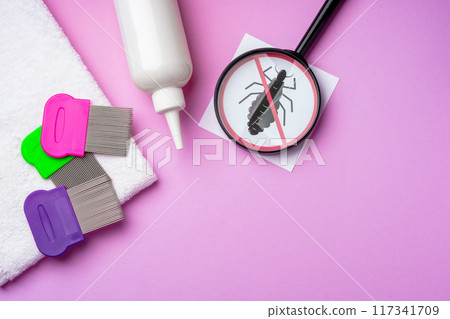 Anti lice combs and towel on pink background 117341709