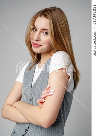 Joyful Young Blonde Woman Smiling against gray background Joyful Young Blonde Woman Smiling against gray background 117341851