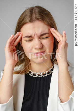 Woman Holding Her Head in Hands in Studio Woman Holding Her Head in Hands in Studio 117341853
