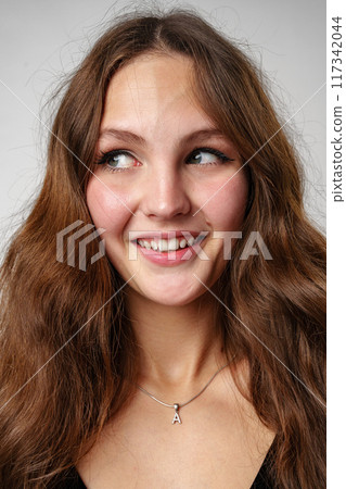 Woman With Long Brown Hair Smiling at Camera Woman With Long Brown Hair Smiling at Camera 117342044