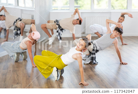 Teenage girl dancing breakdancing in group 117342047