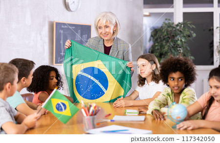Mature female teacher tells the pupils the history of Brazil 117342050