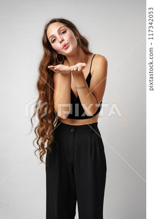 Woman With Long Red Hair Holding Hands Together and kissing 117342053