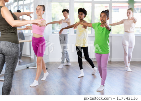 Group of teenage dancers training ballet in studio 117342116