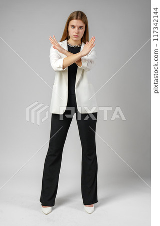 Woman in White Jacket Holding Hands Crossed 117342144