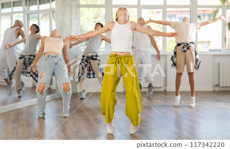 Teenage girl dancing jazz funk in group Teenage girl dancing jazz funk in group 117342220