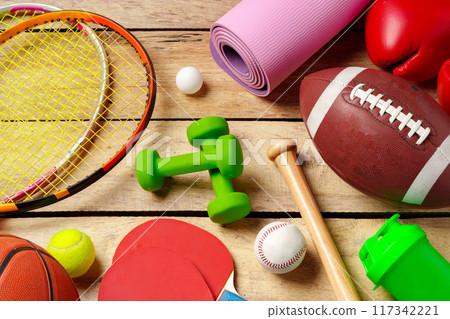 Different sports equipment on wooden background top view Different sports equipment on wooden background top view 117342221
