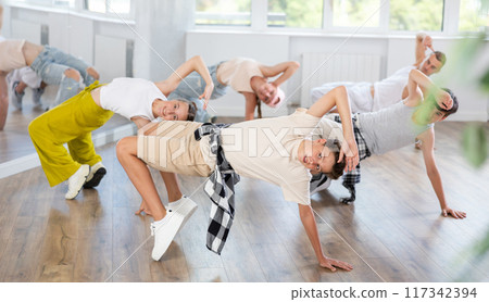 Teen boy dancing breakdancing in group 117342394