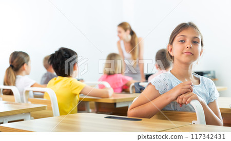 Young girl in classroom Young girl in classroom 117342431
