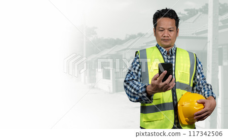 Engineer architect with protective helmet working at house building on construction site background, Housing projects, Residential construction projects. 117342506