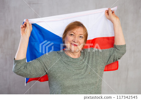 Cheerful senior woman holding flag of Czech Republic Cheerful senior woman holding flag of Czech Republic 117342545