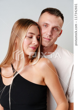 A Man and a Woman Standing Next to Each Other in studio A Man and a Woman Standing Next to Each Other in studio 117342601