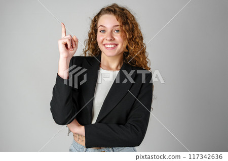 Young Woman in Black Jacket Pointing Up Young Woman in Black Jacket Pointing Up 117342636