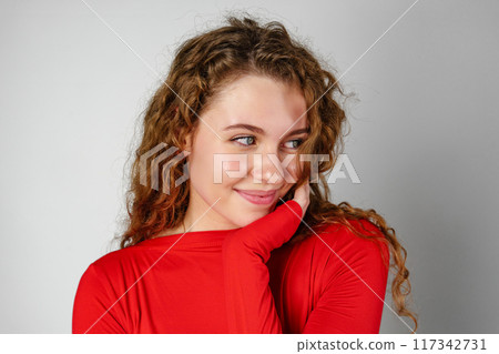 Woman With Curly Hair Standing on Gray Background Woman With Curly Hair Standing on Gray Background 117342731