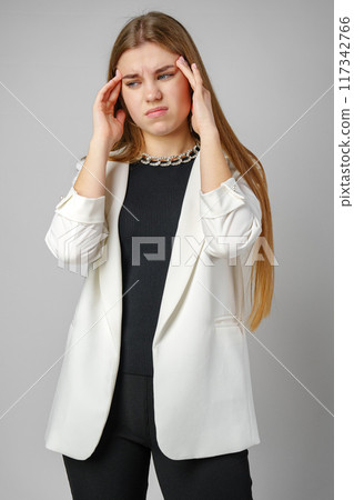 Woman Holding Her Head in Hands in Studio Woman Holding Her Head in Hands in Studio 117342766