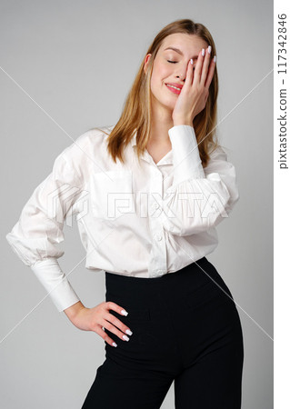 Woman With Hands on Head Suffering Headache Woman With Hands on Head Suffering Headache 117342846