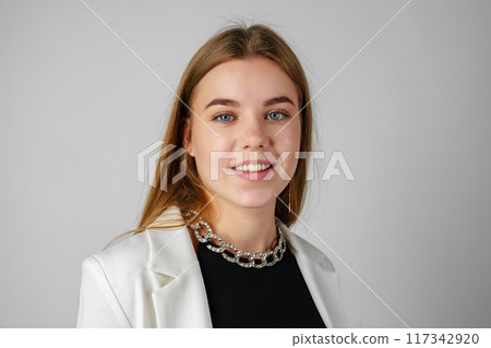 Woman in Black Top and White Jacket Posing in Studio 117342920