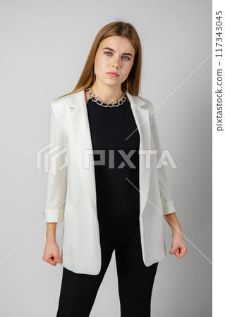 Young Woman Expressing Discontent against gray background Young Woman Expressing Discontent against gray background 117343045