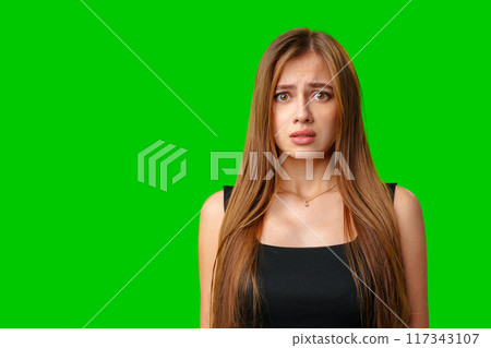 Young Woman With Worried Expression Against Green Screen Background Young Woman With Worried Expression Against Green Screen Background 117343107