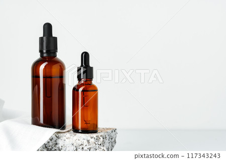 Two Amber Glass Dropper Bottles on White Background 117343243