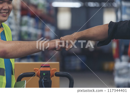 Diversity Teamwork Warehouse worker fist bump together trust partner. Engineer man, women hands partnership. Coworker colleague logistics Warehouse agreement. Multiracial Two people fist bump partner 117344401
