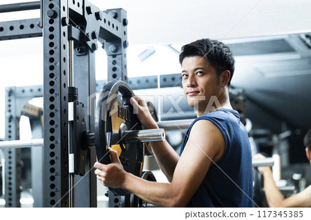 Sports gym, training gym, male, muscle training, portrait 117345385
