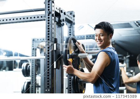 Sports gym, training gym, male, muscle training, portrait 117345389