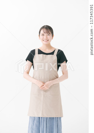 Female cafe staff wearing an apron Female cafe staff wearing an apron 117345391