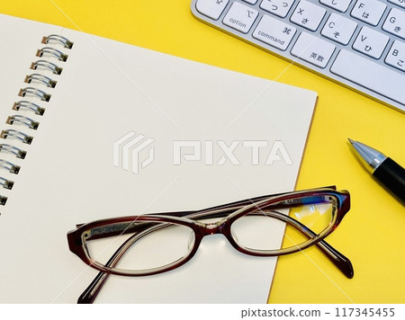 Glasses and a PC placed on top of a ring notebook Glasses and a PC placed on top of a ring notebook 117345455