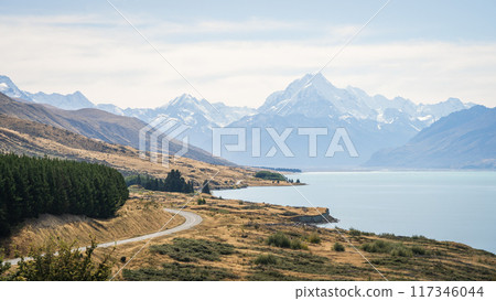 Beautiful autumn alpine landscape with turquoise glacial lake and huge snowy mountains in backdrop 117346044