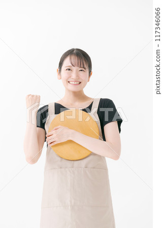Female cafe staff wearing an apron Female cafe staff wearing an apron 117346066