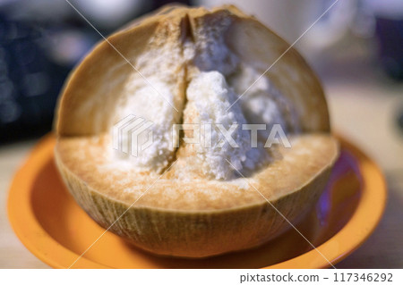 Half Santol on wooden background. Santol has sour taste and the middle of santol is sweeter. 117346292