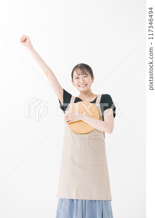 Female cafe staff wearing an apron Female cafe staff wearing an apron 117346494