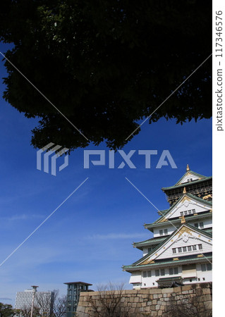 Famous Japanese Castles: Osaka Castle's keep against the blue sky Famous Japanese Castles: Osaka Castle's keep against the blue sky 117346576