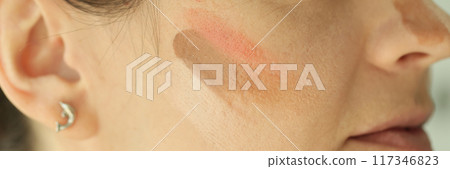 Woman face with tone cream lines on skin Woman face with tone cream lines on skin 117346823