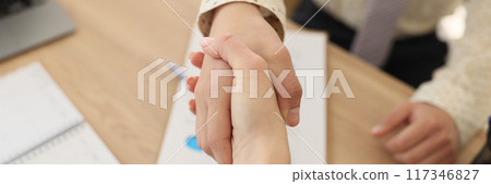 Female and male shaking hands in office 117346827