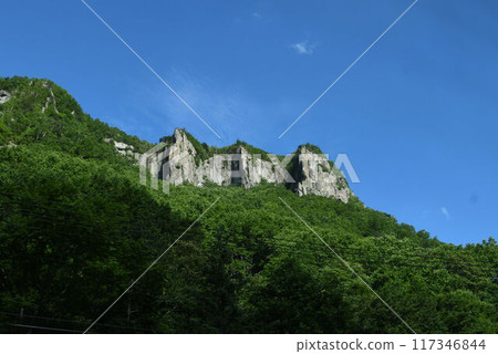 Sounkyo Gorge is a majestic and beautiful place with towering cliffs against the blue sky along the Ishikari River in Hokkaido. Sounkyo Gorge is a majestic and beautiful place with towering cliffs against the blue sky along the Ishikari River in Hokkaido. 117346844