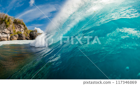 Barrel wave in ocean. Blue wave with sunlight. Panoramic view 117346869